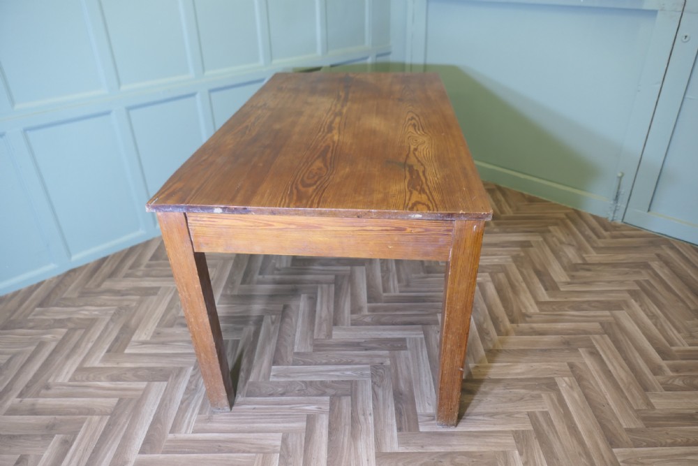 A rectangular antique pine writing table featuring two front drawers fitted with brass cup handles and supported by four straight square legs. View VII
