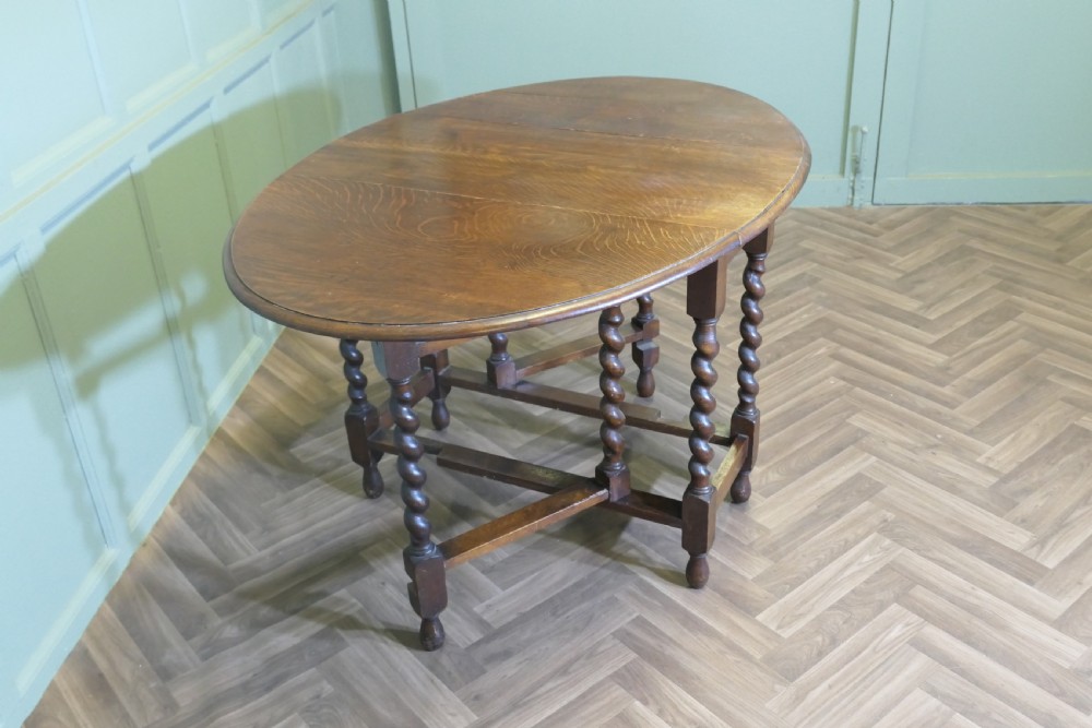A late nineteenth-century oak gateleg dining table featuring drop-leaf sides and barley twist legs. View II