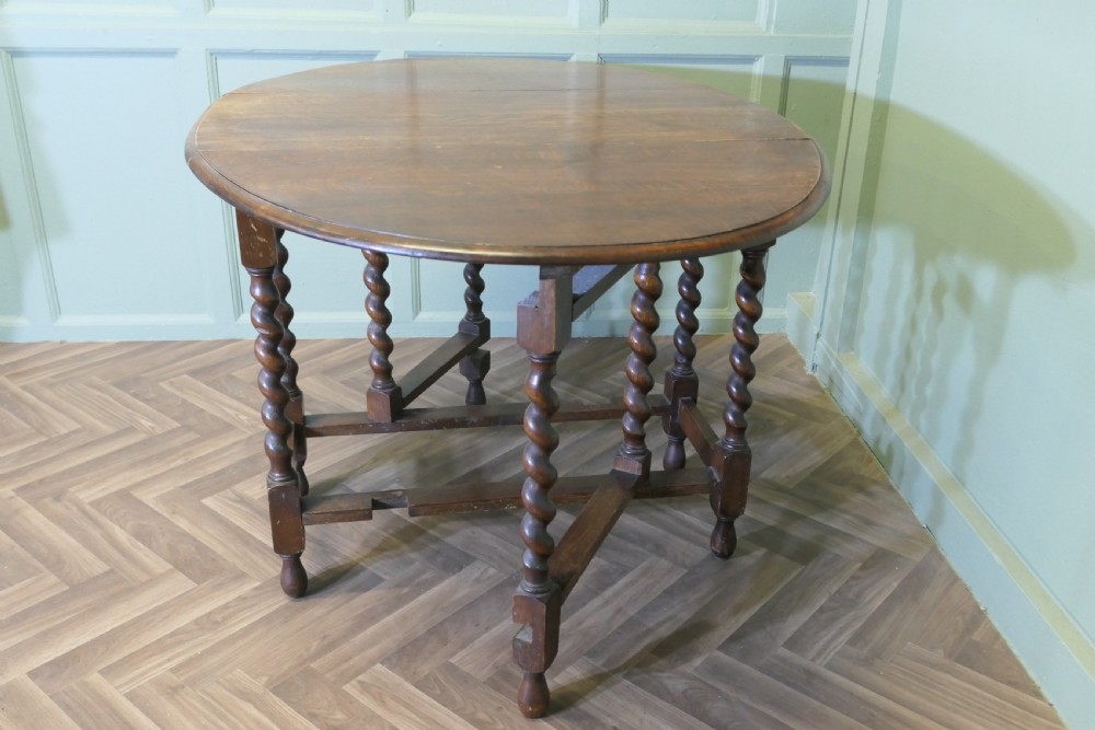 A late nineteenth-century oak gateleg dining table featuring drop-leaf sides and barley twist legs. View III