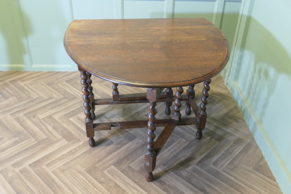 A late nineteenth-century oak gateleg dining table featuring drop-leaf sides and barley twist legs. View V