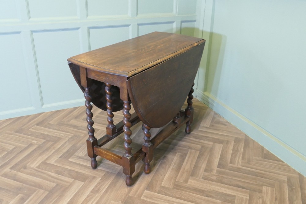 A late nineteenth-century oak gateleg dining table featuring drop-leaf sides and barley twist legs. View VI
