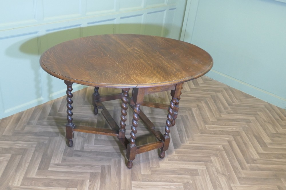 A late nineteenth-century oak gateleg dining table featuring drop-leaf sides and barley twist legs. View VII