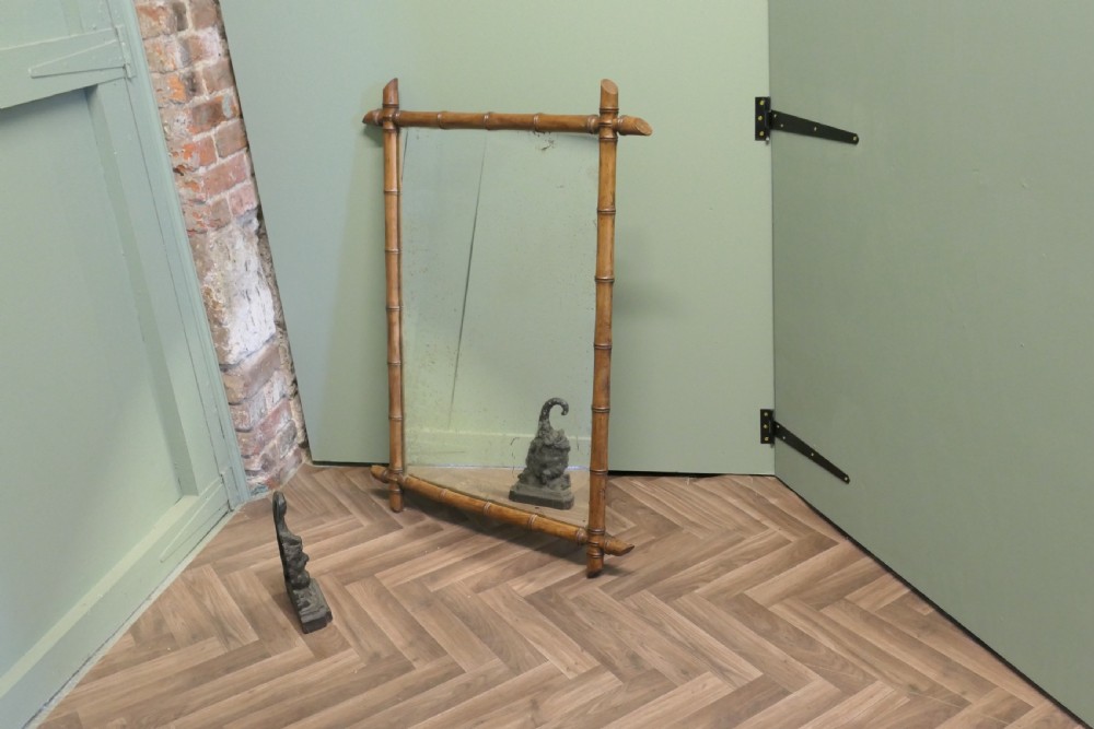 A rectangular French wall mirror featuring a natural bamboo frame with crossed corner joints. View V