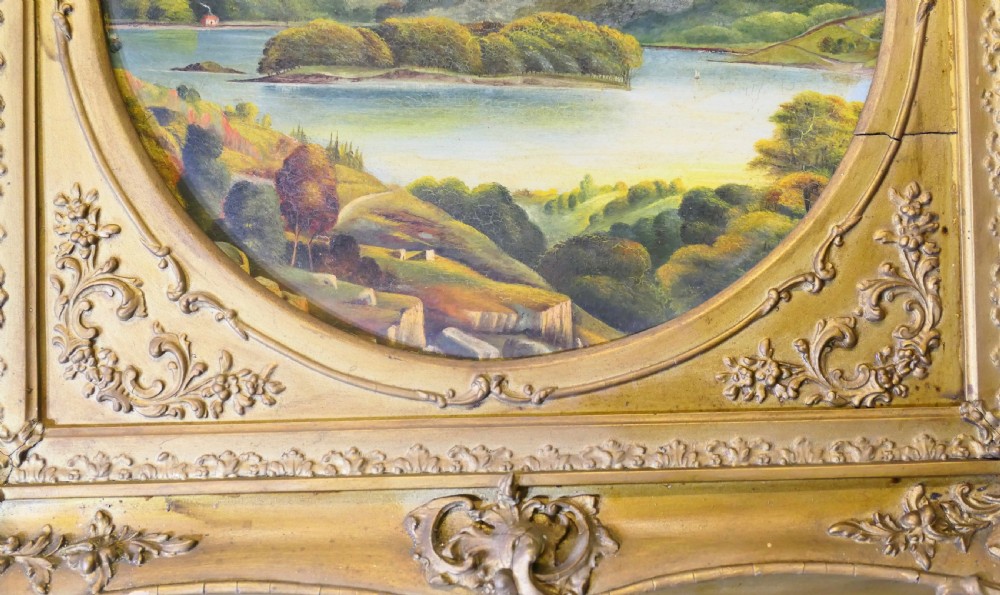 A Victorian oil landscape painting depicting mountains and a lake, set inside a circular aperture framed by a heavy square gilded gesso frame. View VI