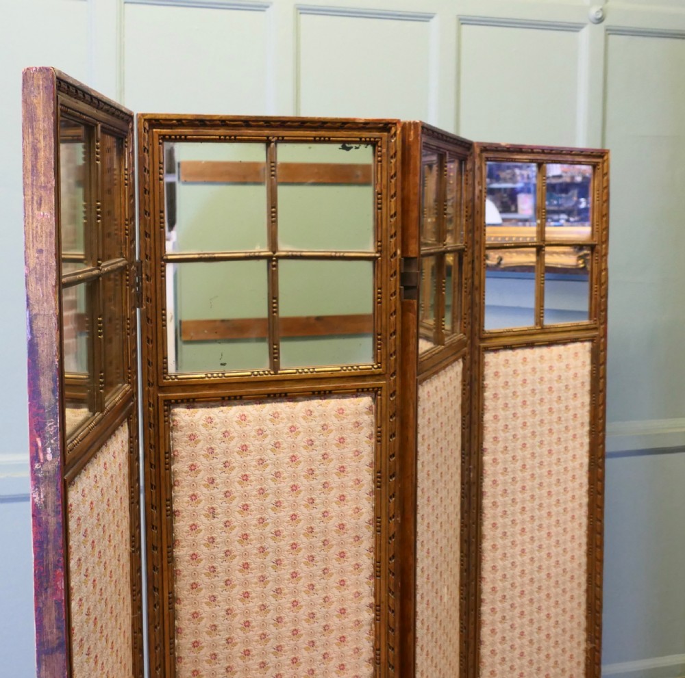A four-panel French folding screen featuring gilded wood frames, glazed mirror panes at the top, and upholstered fabric lower sections. View IV
