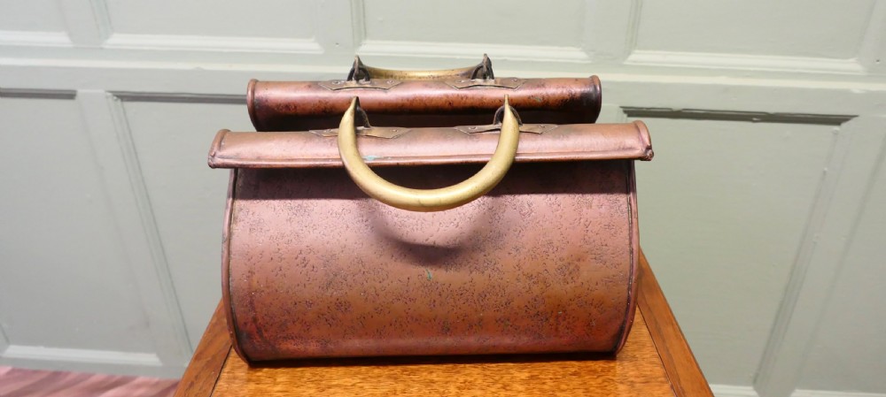 An antique Arts and Crafts copper planter formed in the shape of a Gladstone bag with brass loop handles.