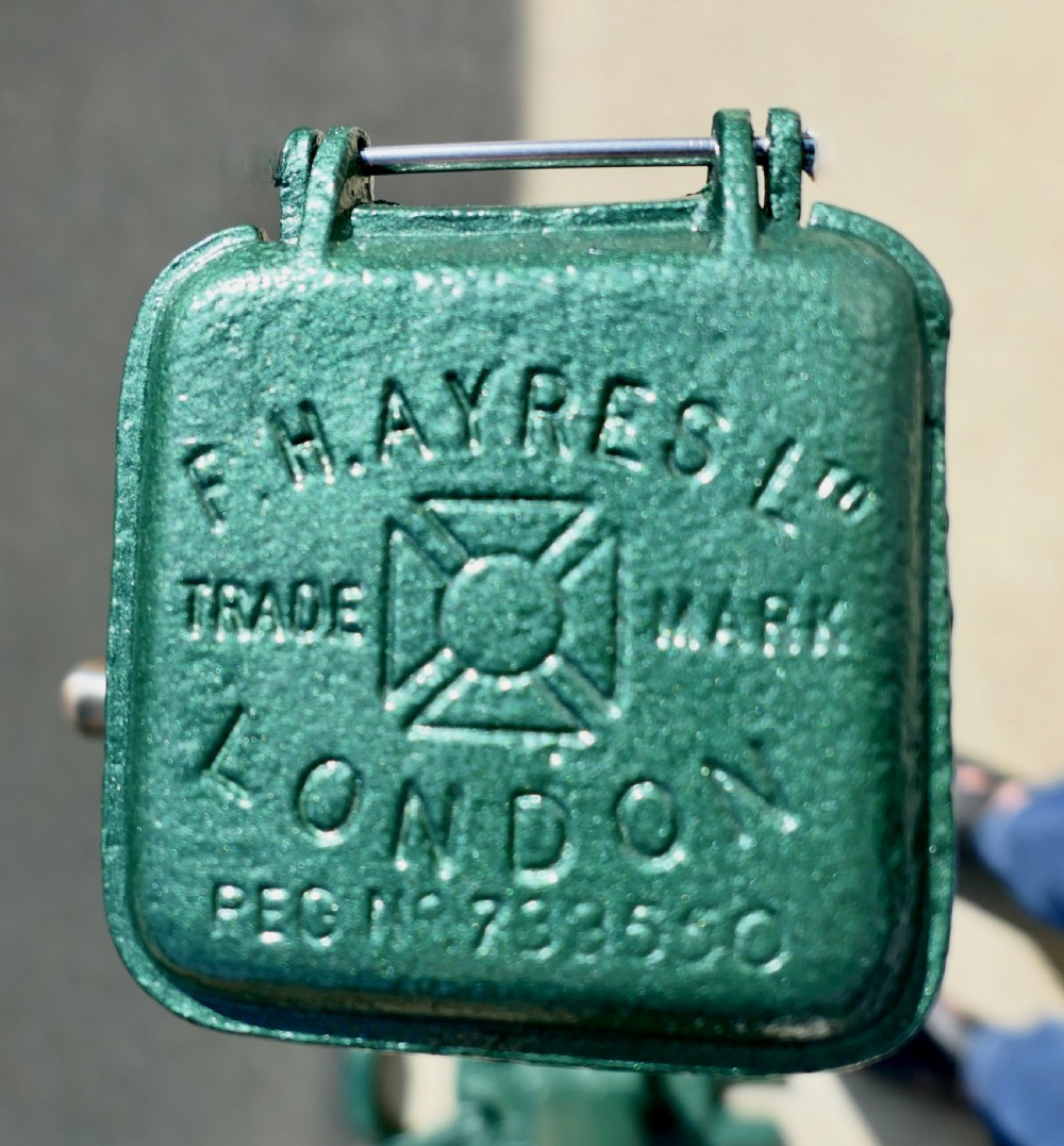 A pair of dark green painted Edwardian metal tennis court net posts featuring mechanical winder handles and heavy cast bases. View II