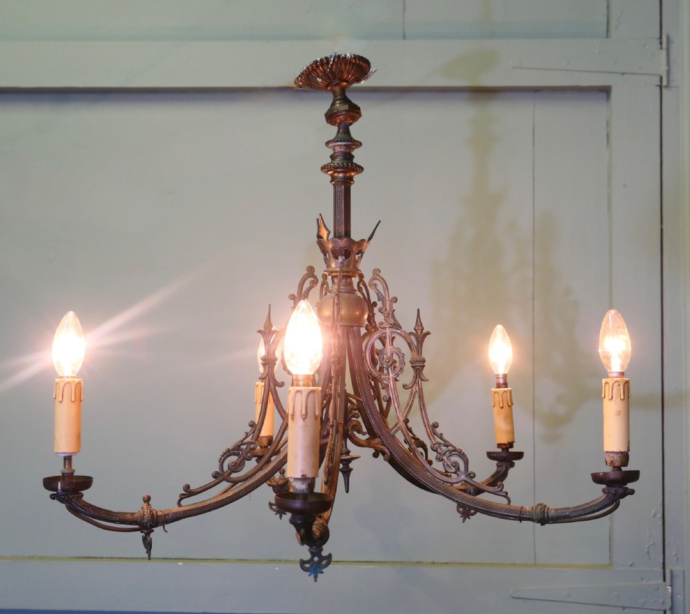 A five-branch gilded brass chandelier featuring Gothic revival openwork tracery, scrolling arms, and candle-style bulb holders. View II