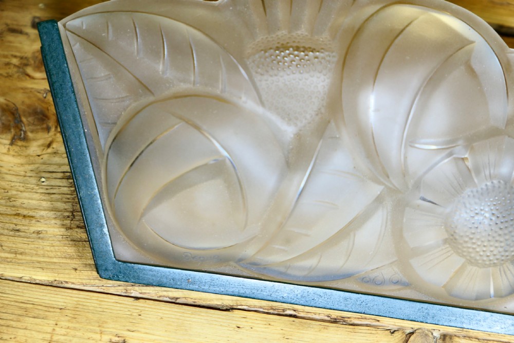 A French Art Deco frosted glass wall light shade featuring press-moulded relief details of stylized flowers and foliage set within a dark metal frame. View VI