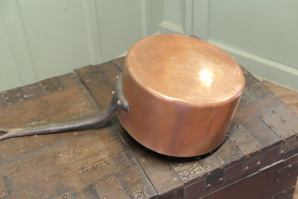 A large 19th-century French copper pot featuring a long iron handle secured with rivets and a tin-lined interior. View II