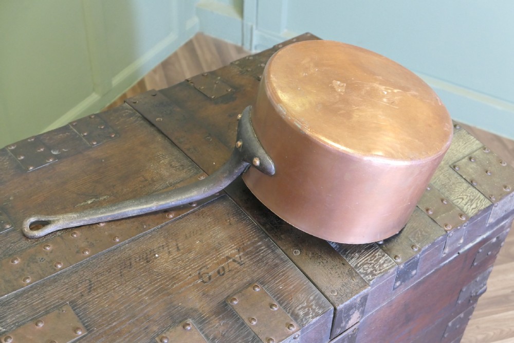 A large 19th-century French copper pot featuring a long iron handle secured with rivets and a tin-lined interior. View VI