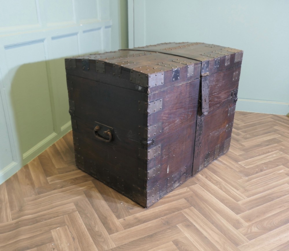 A 19th-century dark oak silver chest reinforced with riveted iron bands, corner brackets, side handles, and a front iron latch.