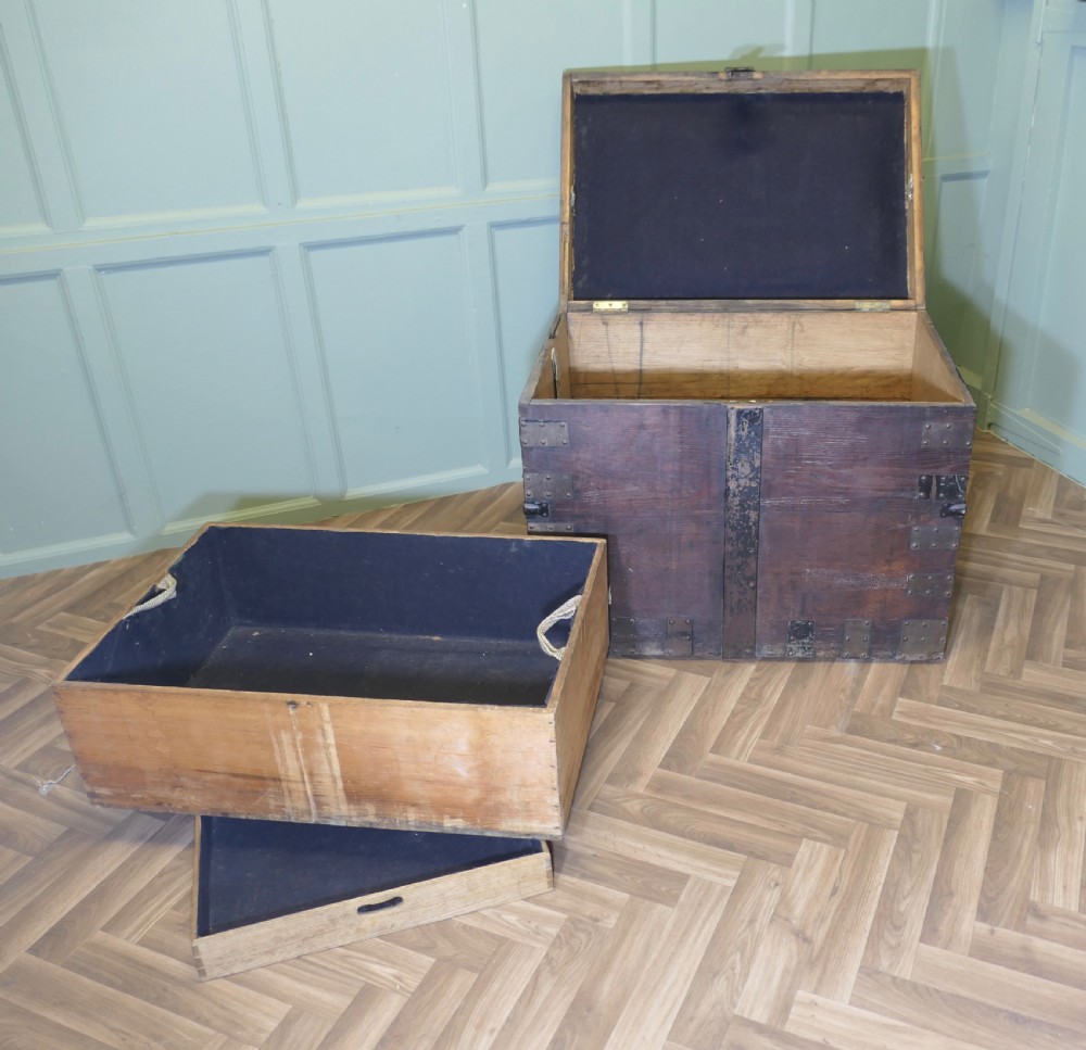 A 19th-century dark oak silver chest reinforced with riveted iron bands, corner brackets, side handles, and a front iron latch. View II