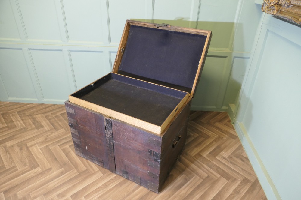 A 19th-century dark oak silver chest reinforced with riveted iron bands, corner brackets, side handles, and a front iron latch. View IV