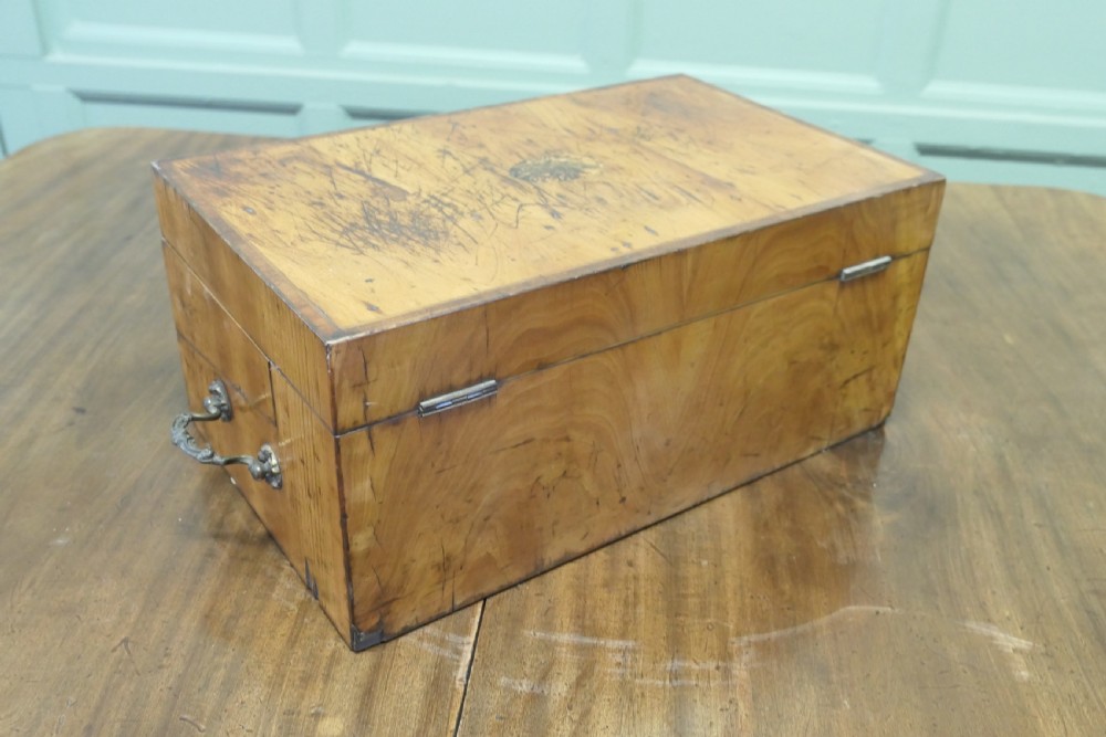 An opened 18th-century satinwood writing slope displaying a green baize writing surface, internal pen tray, glass inkwells, and attached candle sconces. View VII