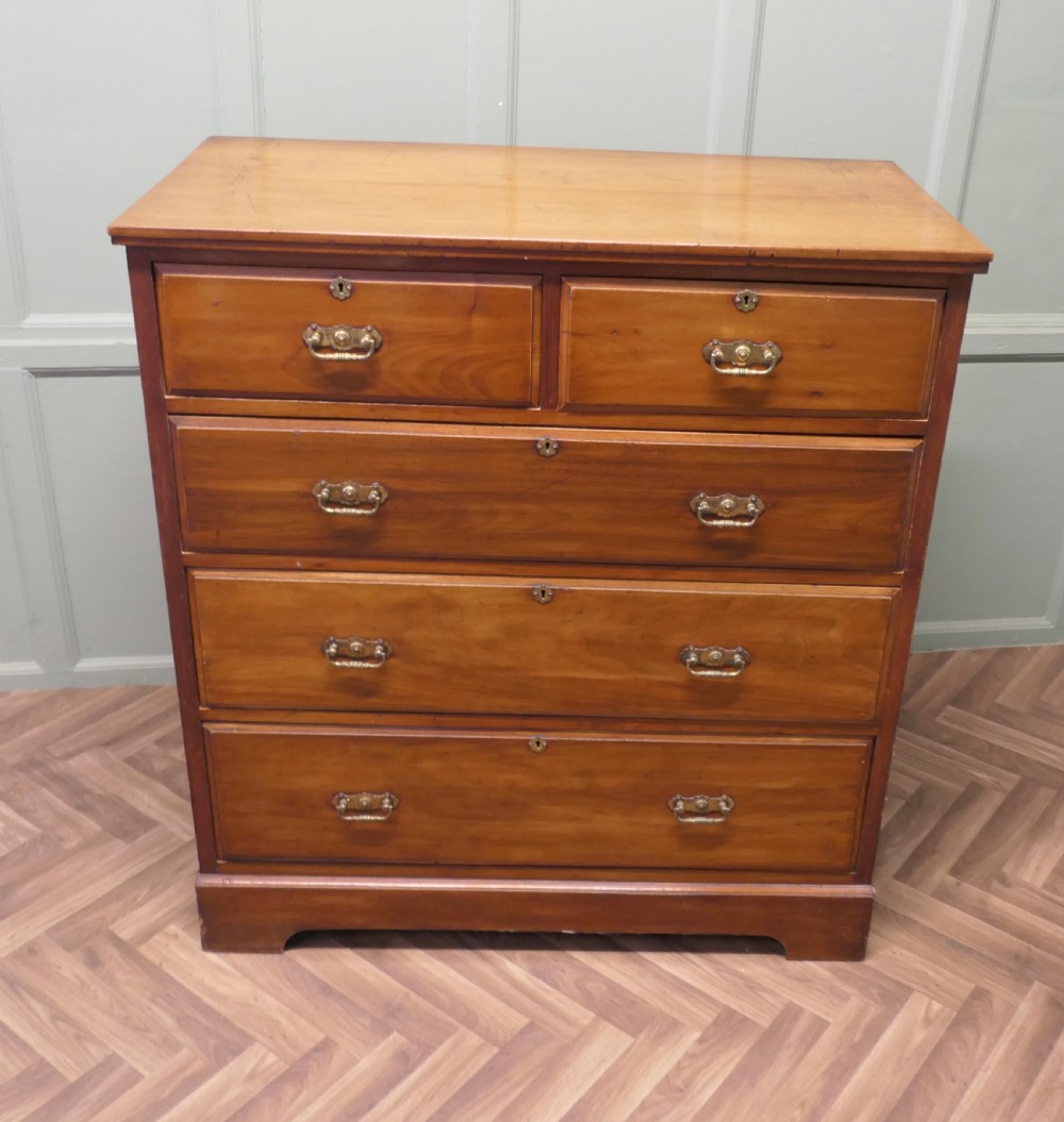A large Edwardian walnut chest of drawers featuring two short drawers over three long drawers with brass drop handles. View III