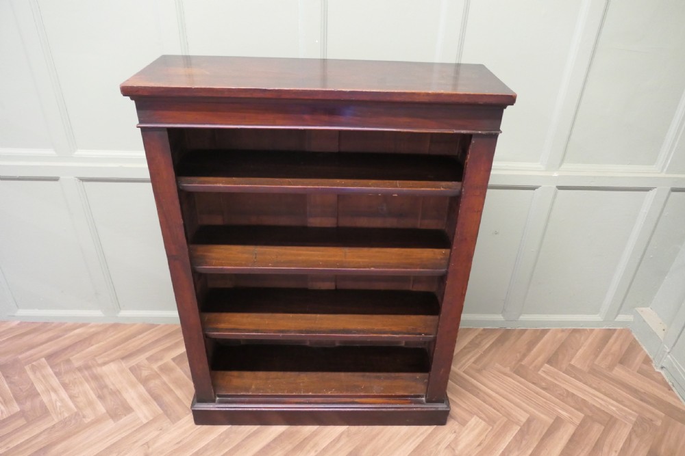 A Victorian dark mahogany open bookcase featuring four adjustable shelves, a simple moulded top cornice, and a sturdy plinth base. View II