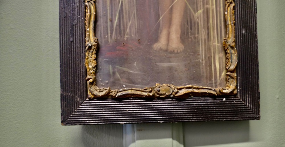 A vertical framed print depicting a classical female figure standing among tall reeds, encased within an ornate gilt inner moulding and a ribbed black timber frame. View IV