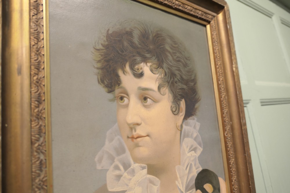 A framed oil portrait painting on board depicting a woman with short curly hair holding a black masquerade mask, dressed in a ruffled collar inside a gilded wood frame. View VI