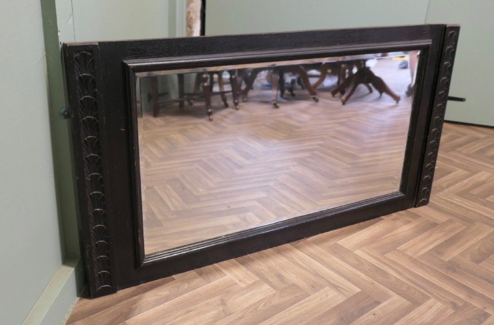 A large nineteenth-century rectangular mirror featuring a dark stained oak frame with carved foliate borders along the vertical sides. View III