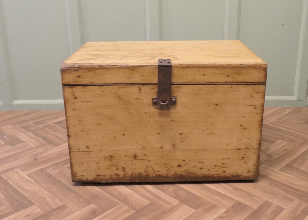 A rectangular golden oak travelling silver chest featuring a hinged lid and central iron locking latch.