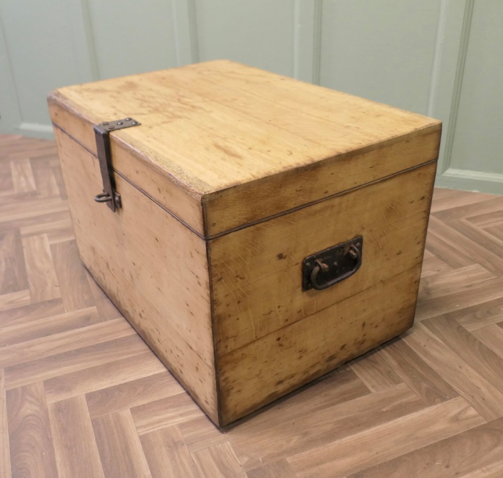 A rectangular golden oak travelling silver chest featuring a hinged lid and central iron locking latch. View II