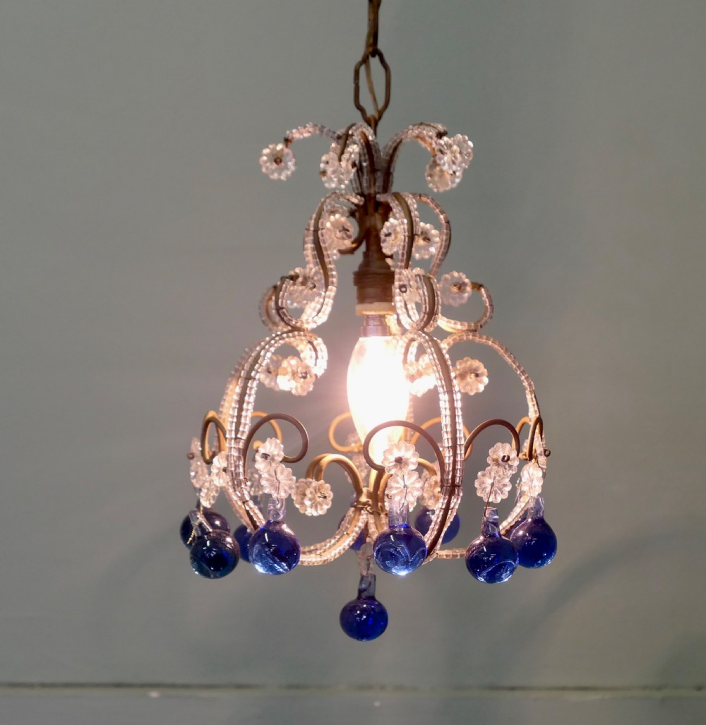 A compact French ceiling light featuring a wire frame adorned with clear glass beads and flower motifs, finished with hanging cobalt blue glass droplets.