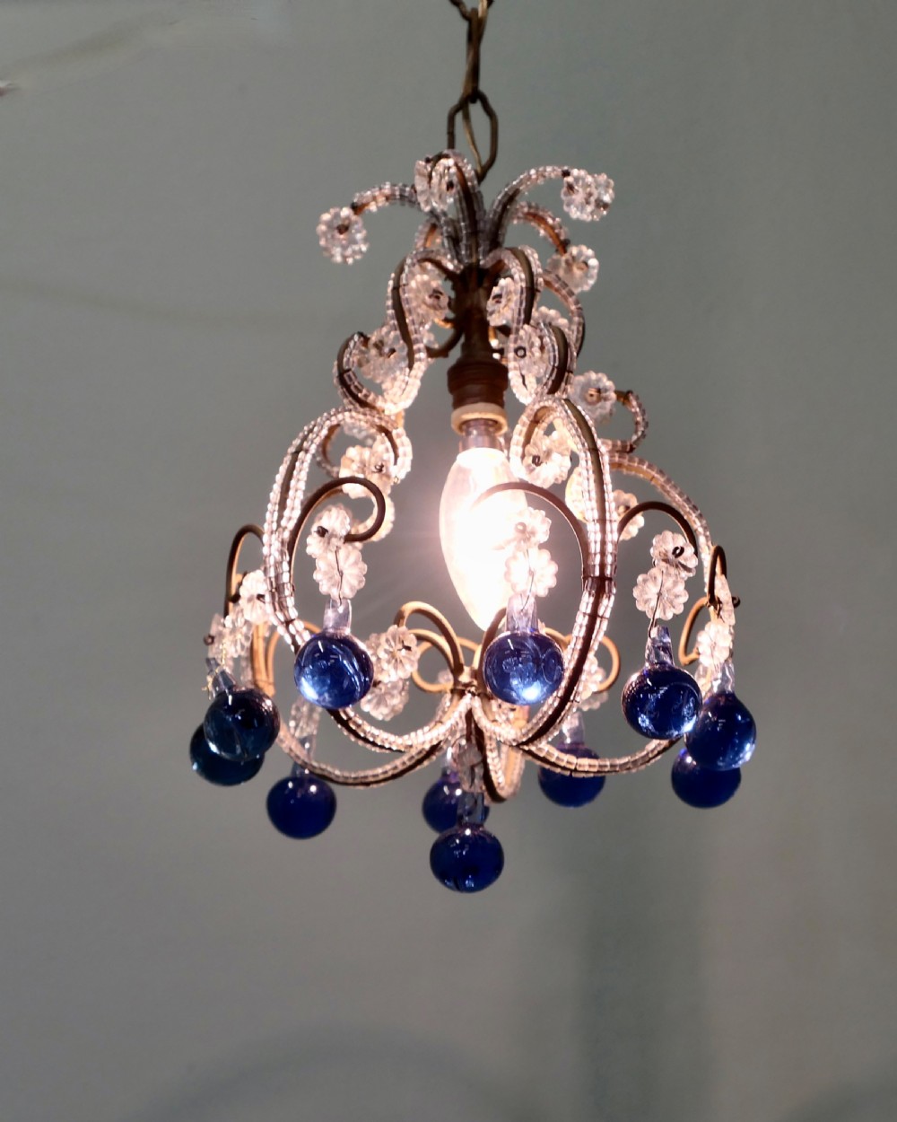 A compact French ceiling light featuring a wire frame adorned with clear glass beads and flower motifs, finished with hanging cobalt blue glass droplets. View III
