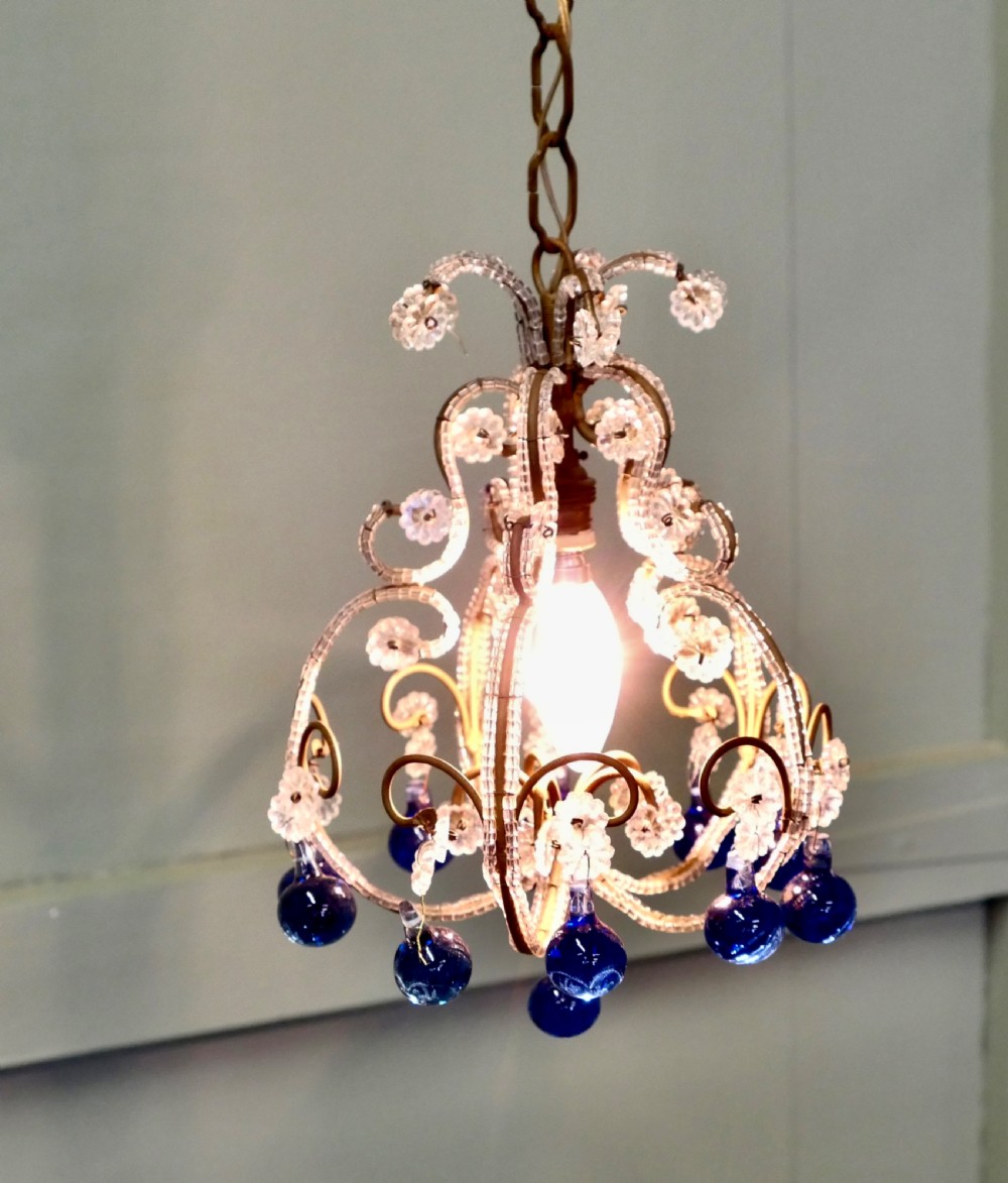 A compact French ceiling light featuring a wire frame adorned with clear glass beads and flower motifs, finished with hanging cobalt blue glass droplets. View V
