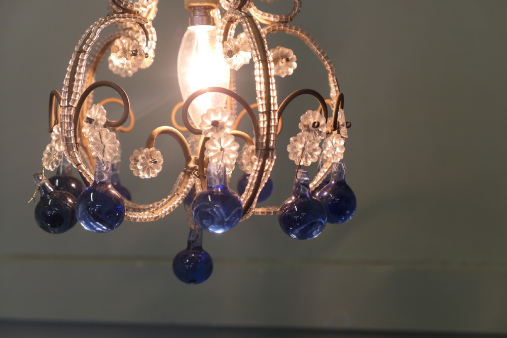 A compact French ceiling light featuring a wire frame adorned with clear glass beads and flower motifs, finished with hanging cobalt blue glass droplets. View VI
