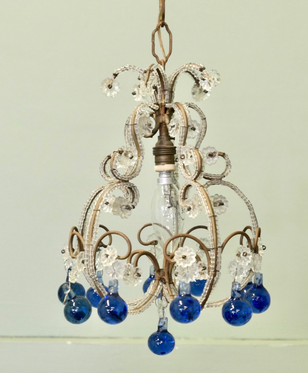 A compact French ceiling light featuring a wire frame adorned with clear glass beads and flower motifs, finished with hanging cobalt blue glass droplets. View VII