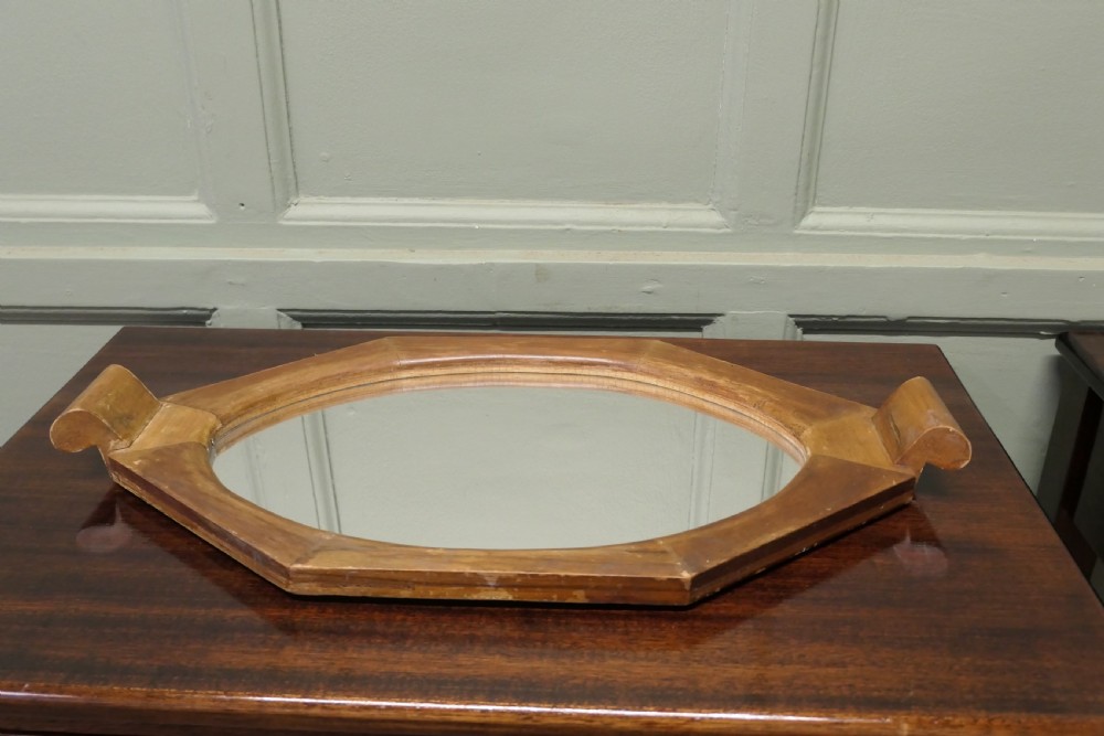 An octagonal wooden Art Deco mirror tray featuring carved scroll side handles and a central glass insert. View II