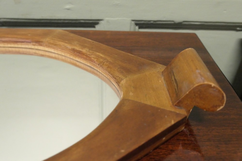 An octagonal wooden Art Deco mirror tray featuring carved scroll side handles and a central glass insert. View VI