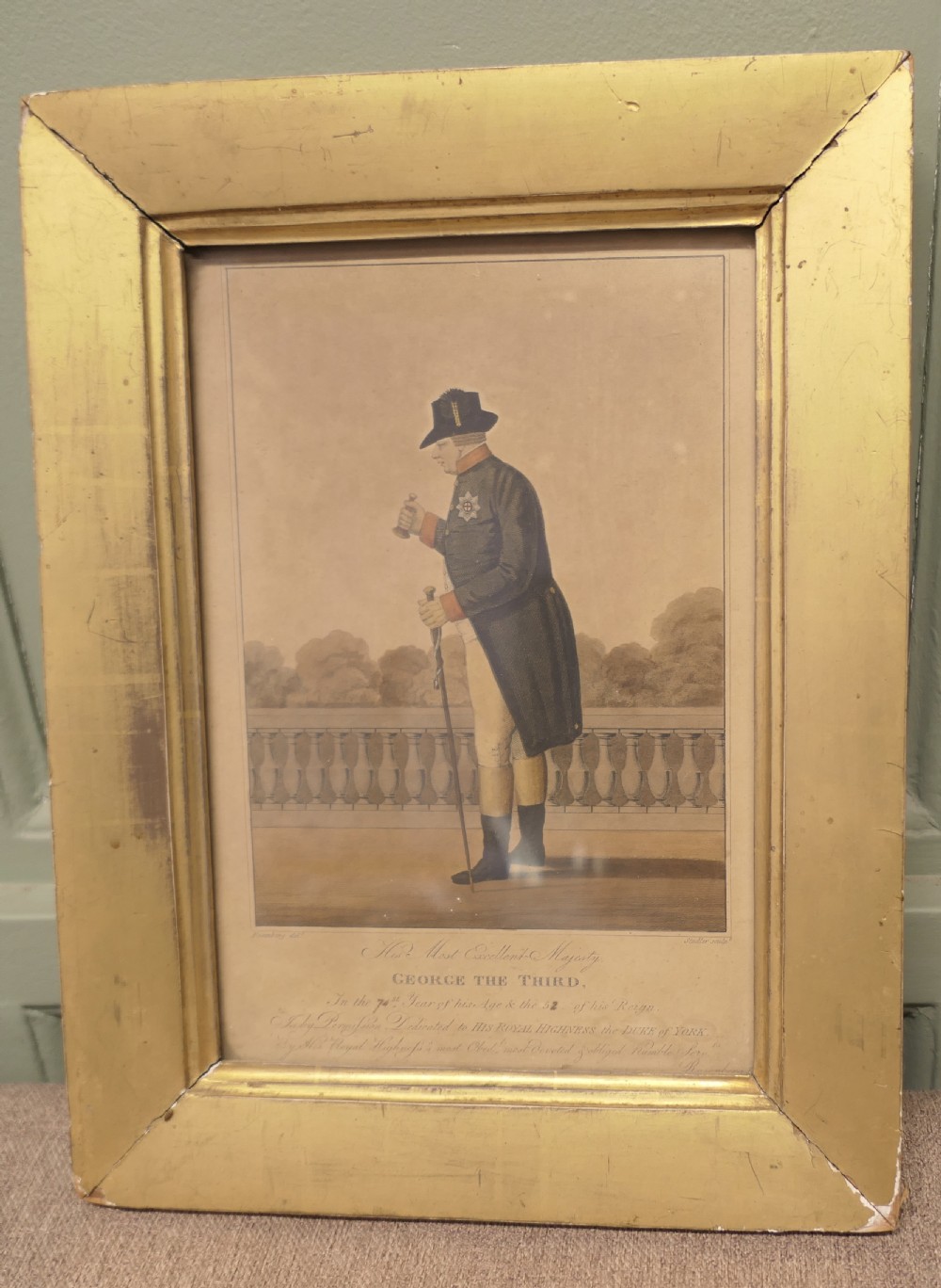An early nineteenth-century framed print depicting King George III in profile, held within a broad gilt wood frame.