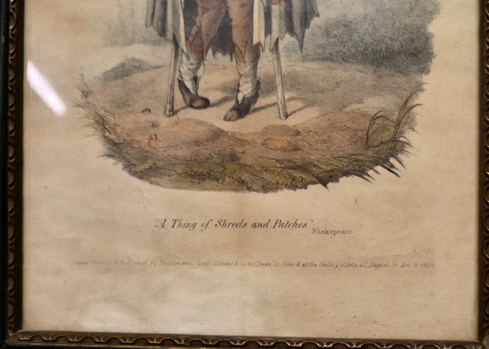 An early nineteenth-century framed hand-coloured print depicting a beggar figure with crutches and a patched cloak, titled A Thing of Shreds and Patches. View IV