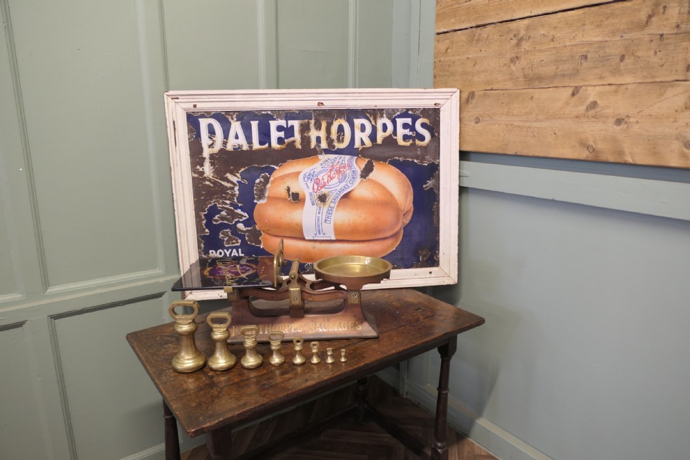 Antique cast iron and brass butcher balance scales with Palethorpes advertising print and a set of brass bell weights. View II