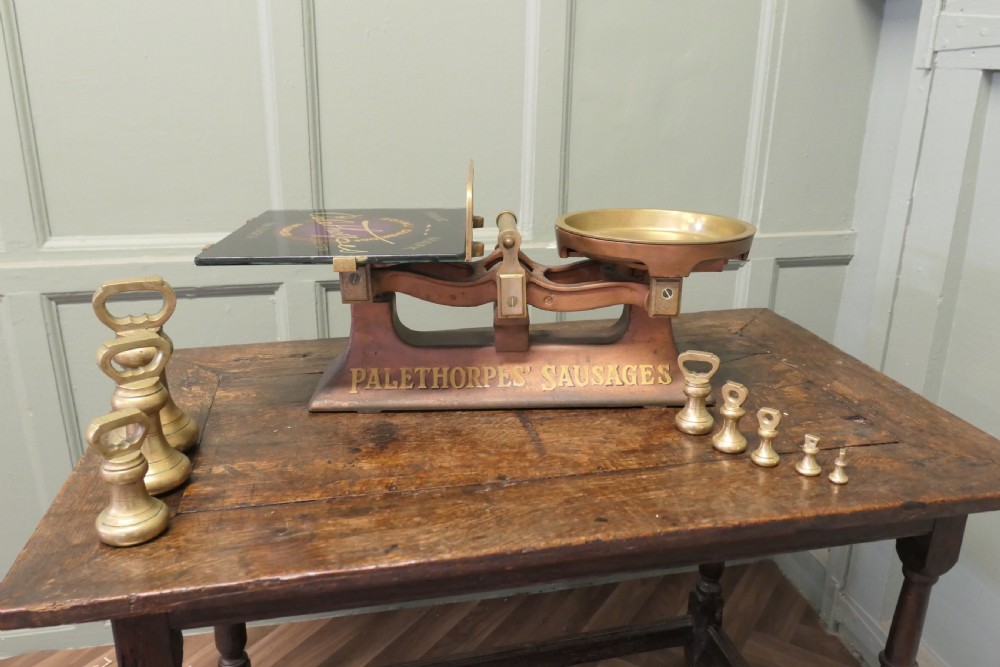 Antique cast iron and brass butcher balance scales with Palethorpes advertising print and a set of brass bell weights. View IV