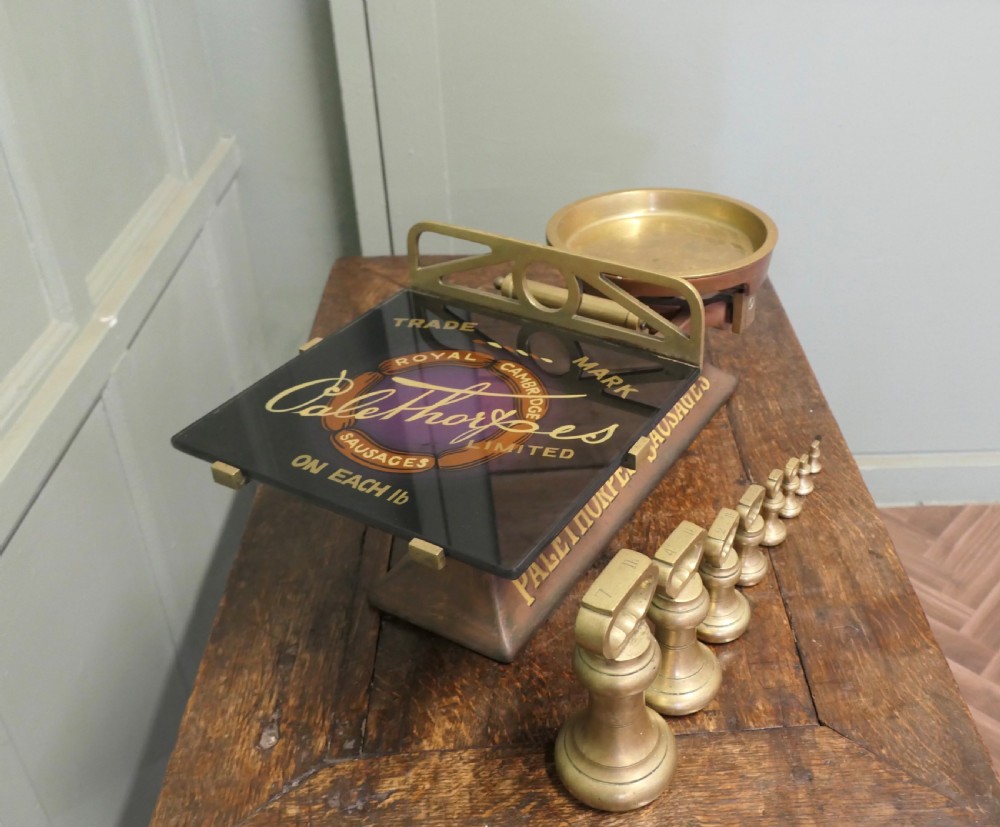 Antique cast iron and brass butcher balance scales with Palethorpes advertising print and a set of brass bell weights. View V