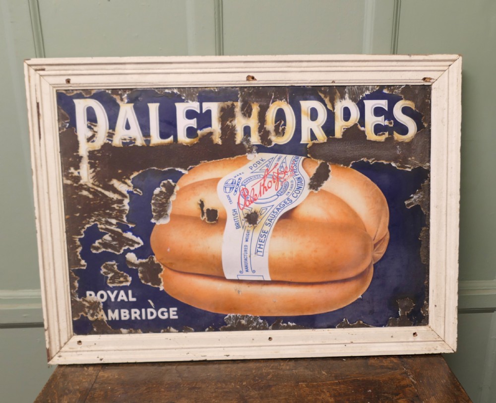 A framed early twentieth-century blue vitreous enamel advertising sign with bold lettering for Palethorpes and a central illustration of packaged sausages.