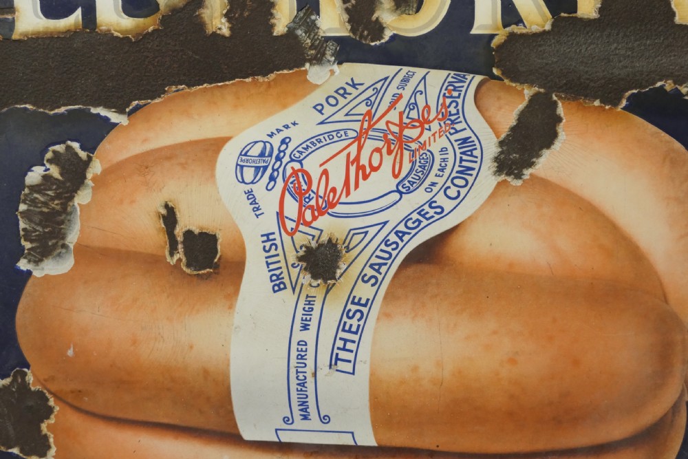 A framed early twentieth-century blue vitreous enamel advertising sign with bold lettering for Palethorpes and a central illustration of packaged sausages. View VI