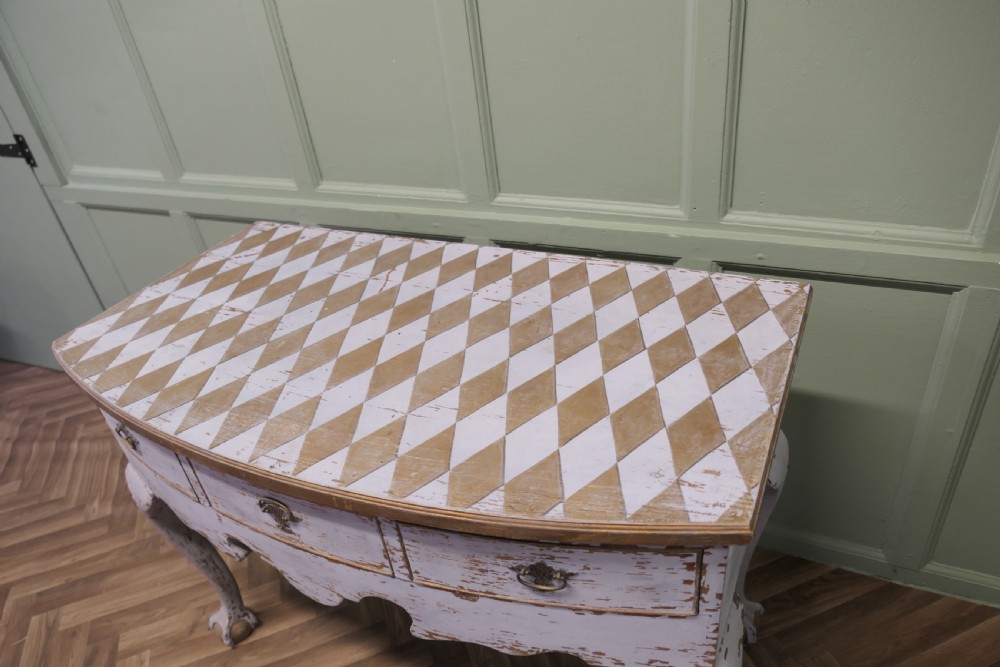 An eighteenth-century style painted bow-front console table featuring a diamond-pattern top, carved shell knees, claw-and-ball feet, and brass drawer handles. View II