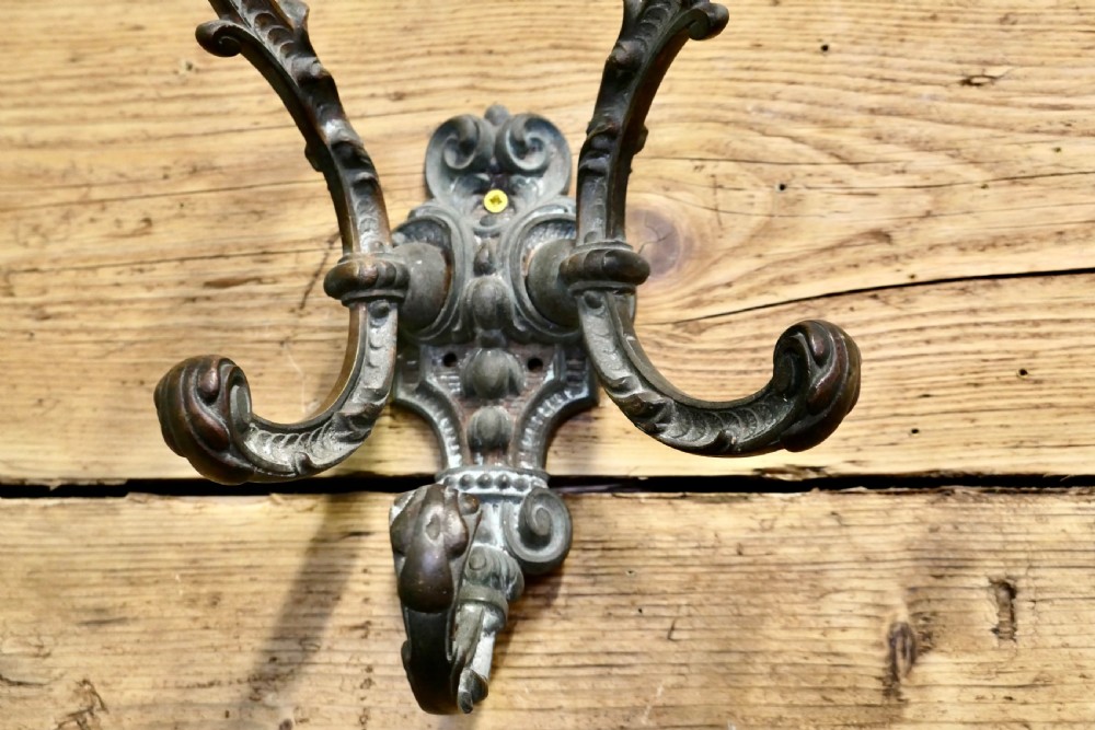 An early nineteenth-century ornate cast bronze hat and coat hook with scrolled detailing and a dark patinated finish. View IV
