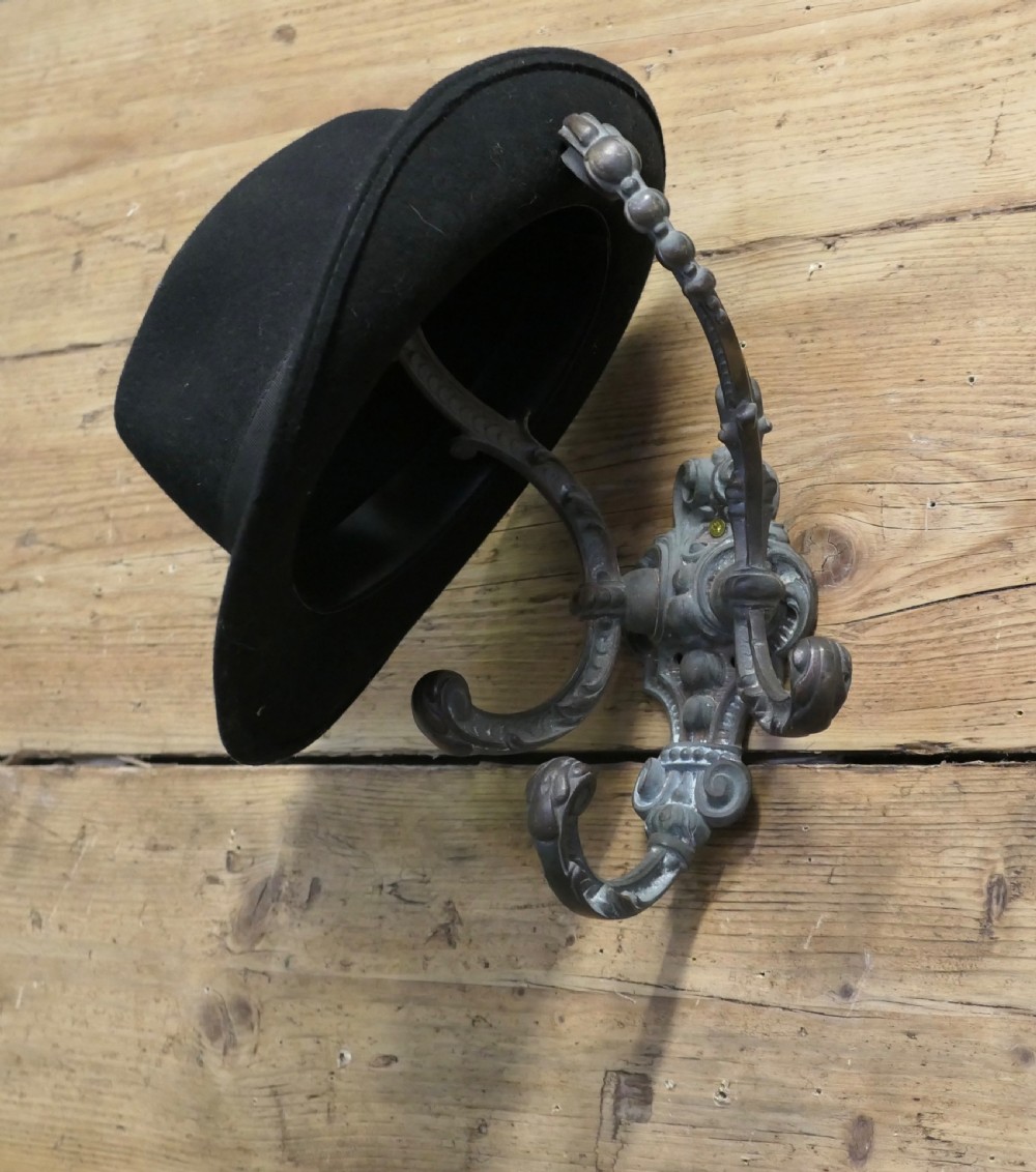 An early nineteenth-century ornate cast bronze hat and coat hook with scrolled detailing and a dark patinated finish. View VI