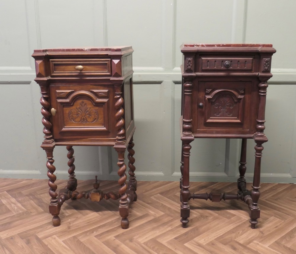 An antique French walnut night table featuring a marble top, a carved drawer, a lower cupboard door with foliate carvings, and barley twist legs. View V