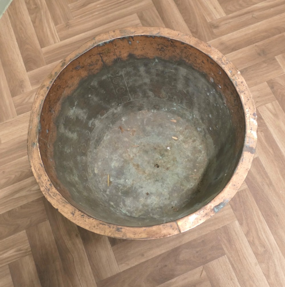 A 19th-century deep copper vessel featuring hand-riveted vertical and base seams with a wide flared rim and natural surface patina. View II
