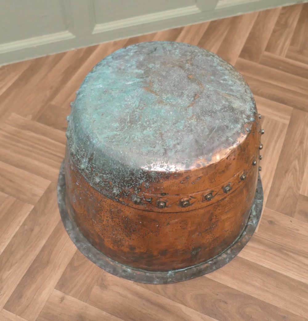 A 19th-century deep copper vessel featuring hand-riveted vertical and base seams with a wide flared rim and natural surface patina. View III