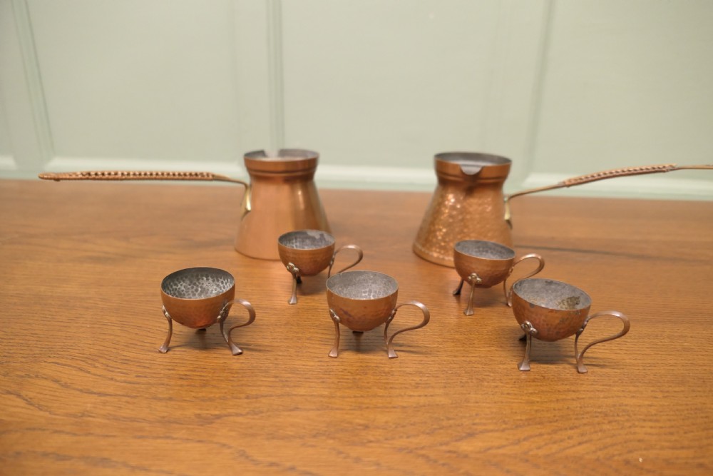A hand-hammered copper pot featuring a long brass handle, pouring spout, and tin-lined interior. View II