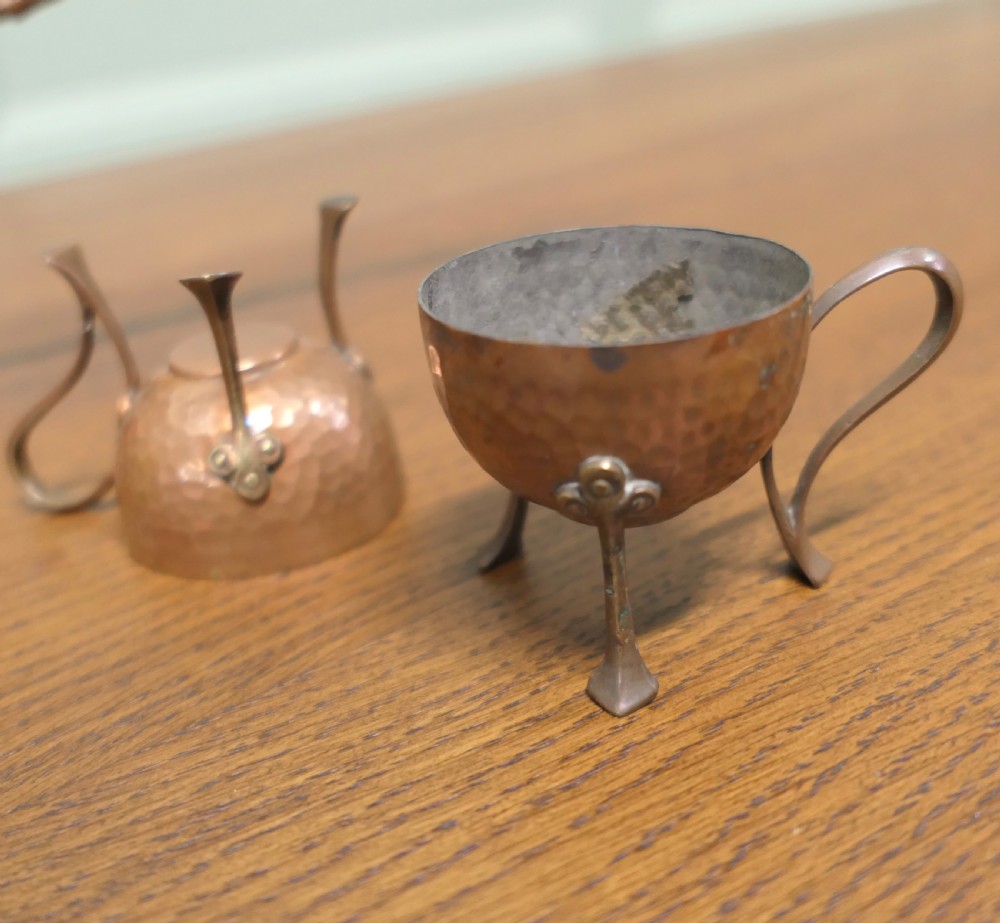 A hand-hammered copper pot featuring a long brass handle, pouring spout, and tin-lined interior. View IV