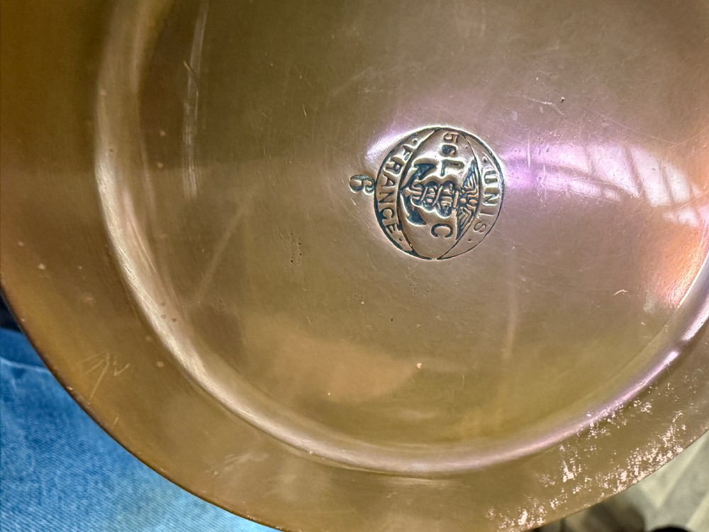 A hand-hammered copper pot featuring a long brass handle, pouring spout, and tin-lined interior. View V