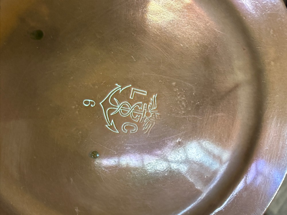 A hand-hammered copper pot featuring a long brass handle, pouring spout, and tin-lined interior. View VI